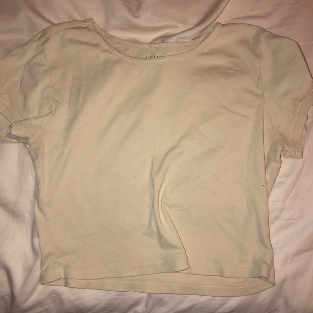 Light/pastel yellowish cream colored crop top